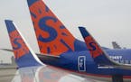 Sun Country airlines logo on 737 wing tips and tail at Humphrey terminal at the Minneapolis-St. Paul International Airport.