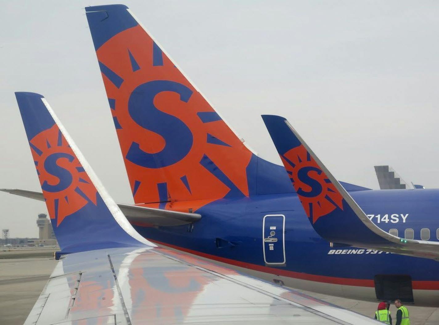 Sun Country airlines logo on 737 wing tips and tail at Humphrey terminal at the Minneapolis-St. Paul International Airport.