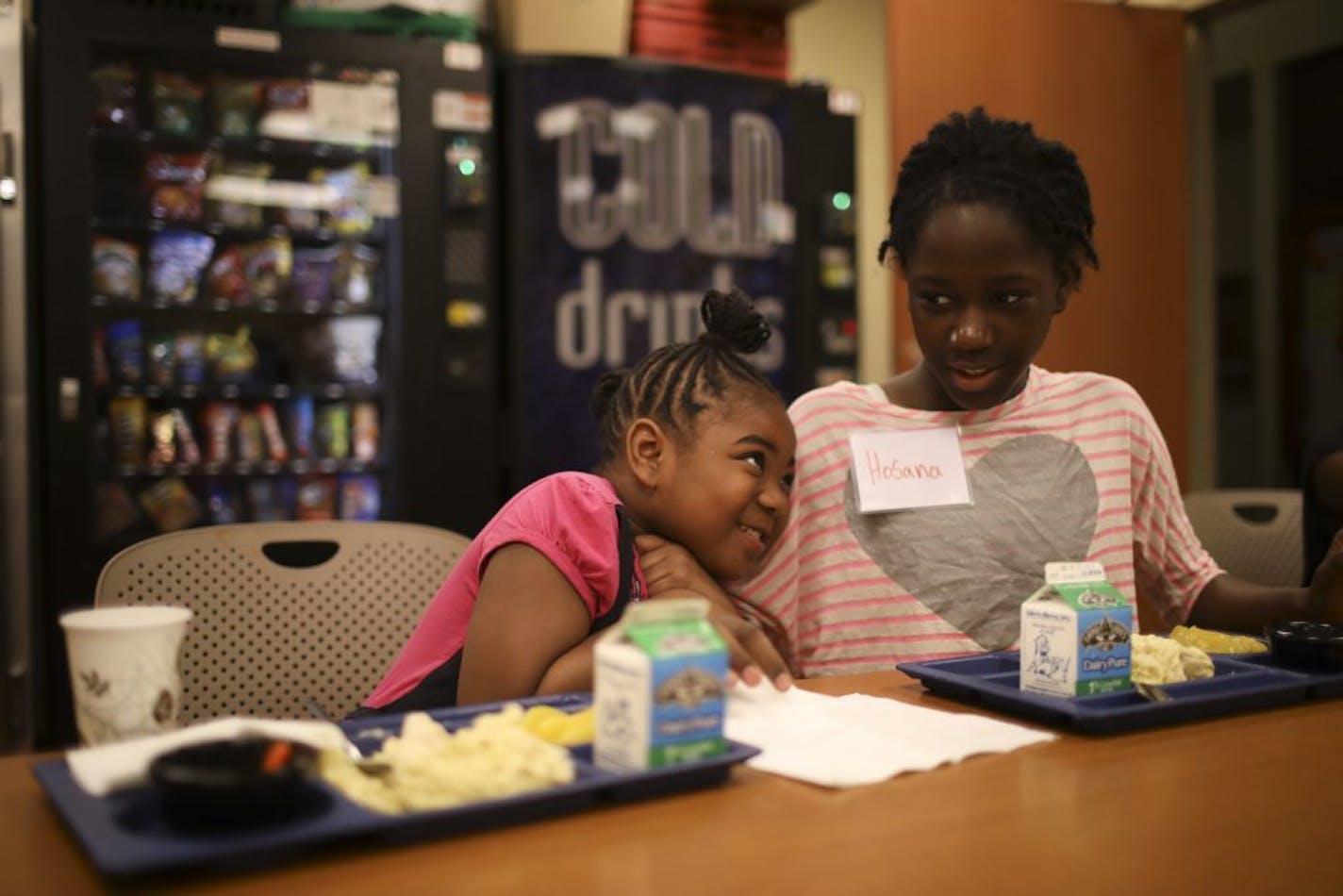 Catalya sat next to her friend, Hosana, at dinner Tuesday evening at Messiah Lutheran Church in Minneapolis.