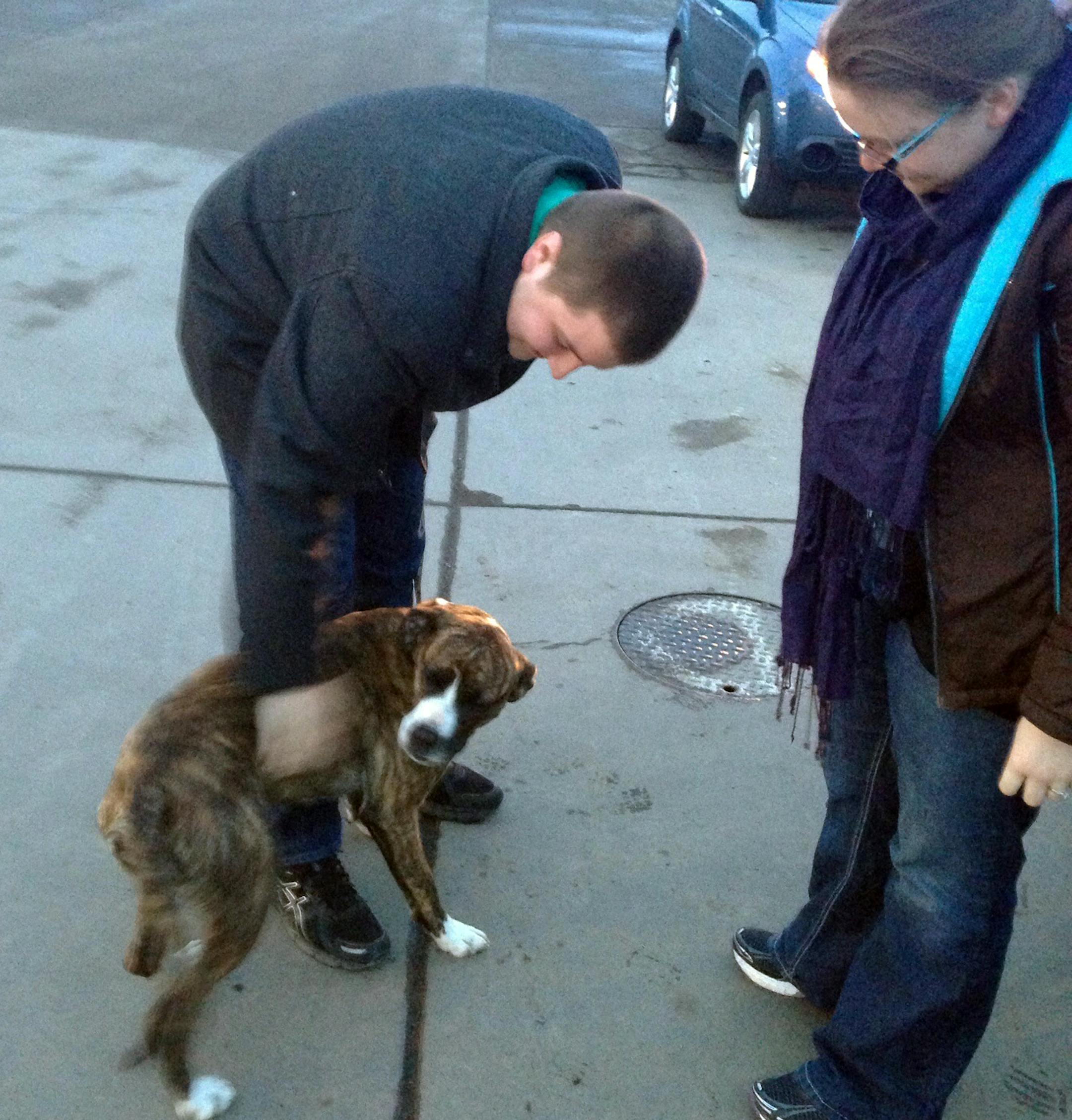 Chad Klavetter, left, and his wife, Liz, greet their dog, Avery in Pine City, Minn.