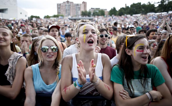 Megan Pohle, 16, middle reacts to the lead singer of Tune-yards Merrill Garbus as she enters the stage to set tone of the 2012 Rock the Garden concert