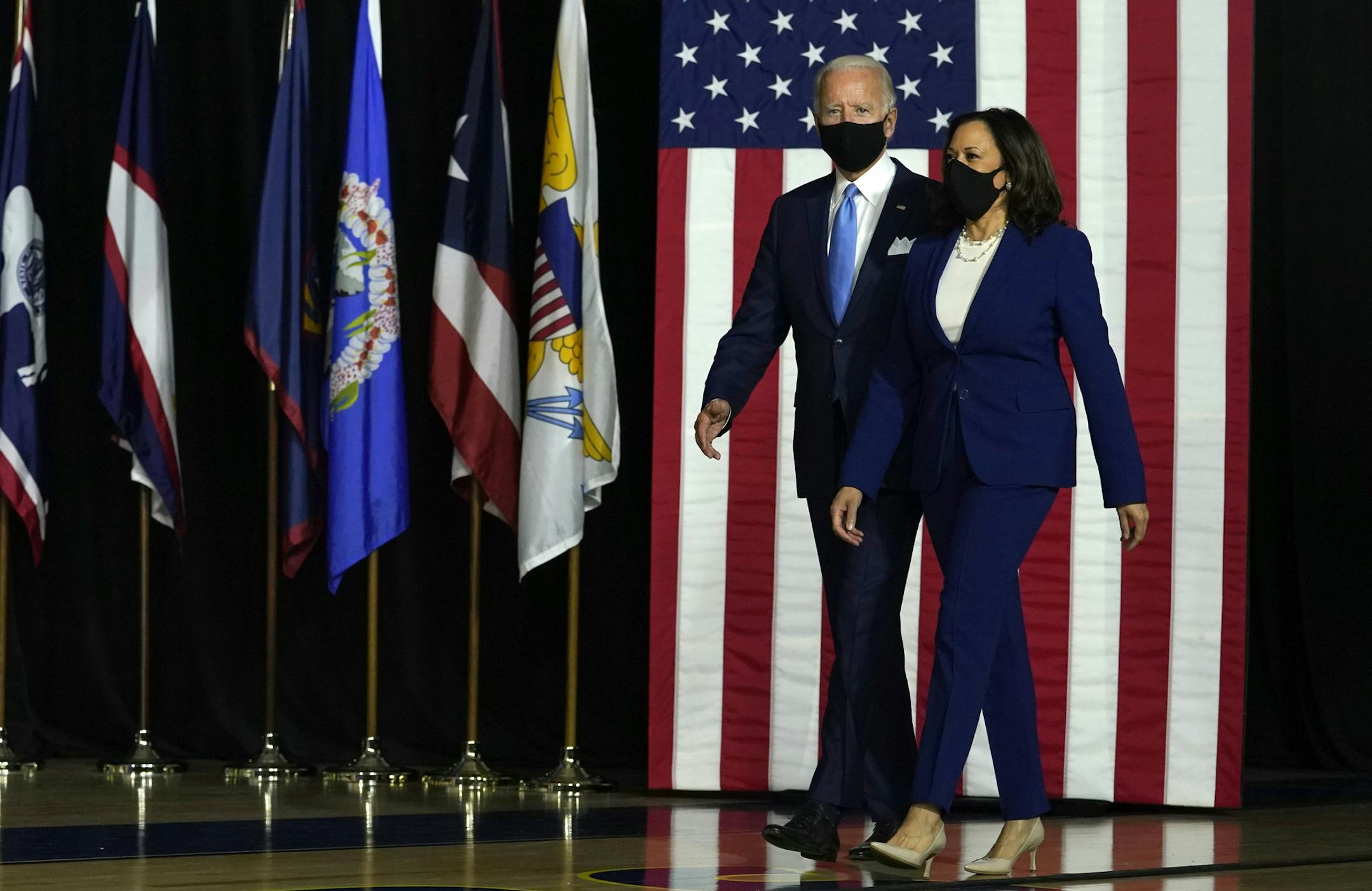 Democratic presidential candidate former Vice President Joe Biden and his running mate Sen. Kamala Harris, D-Calif., arrive to speak at a news conference at Alexis Dupont High School in Wilmington, Del., Wednesday, Aug., 12, 2020. (AP Photo/Carolyn Kaster)