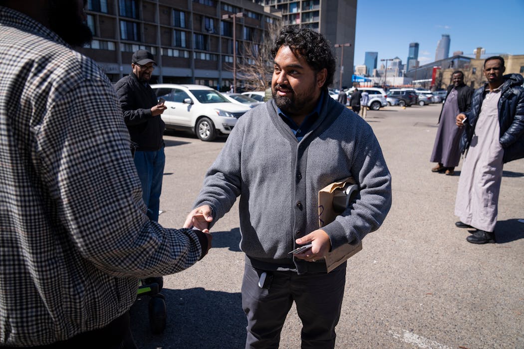 Murid Amini markets his new rideshare business, MOOV, outside a mosque after Friday prayers in the Cedar-Riverside neighborhood in Minneapolis on Friday.