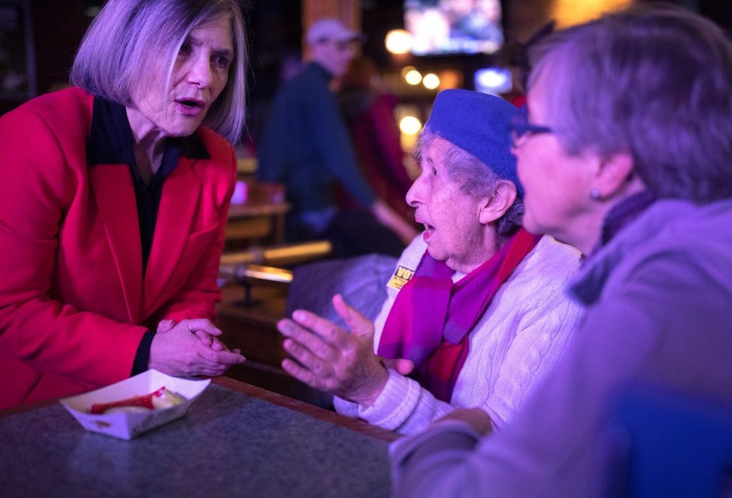 Patty Hartmann spoke with Stephanie Digby and Laura Lein spoke at Plums Neighborhood Grill & Bar as they waited Tuesday night for results in St. Paul's trash-collection vote.