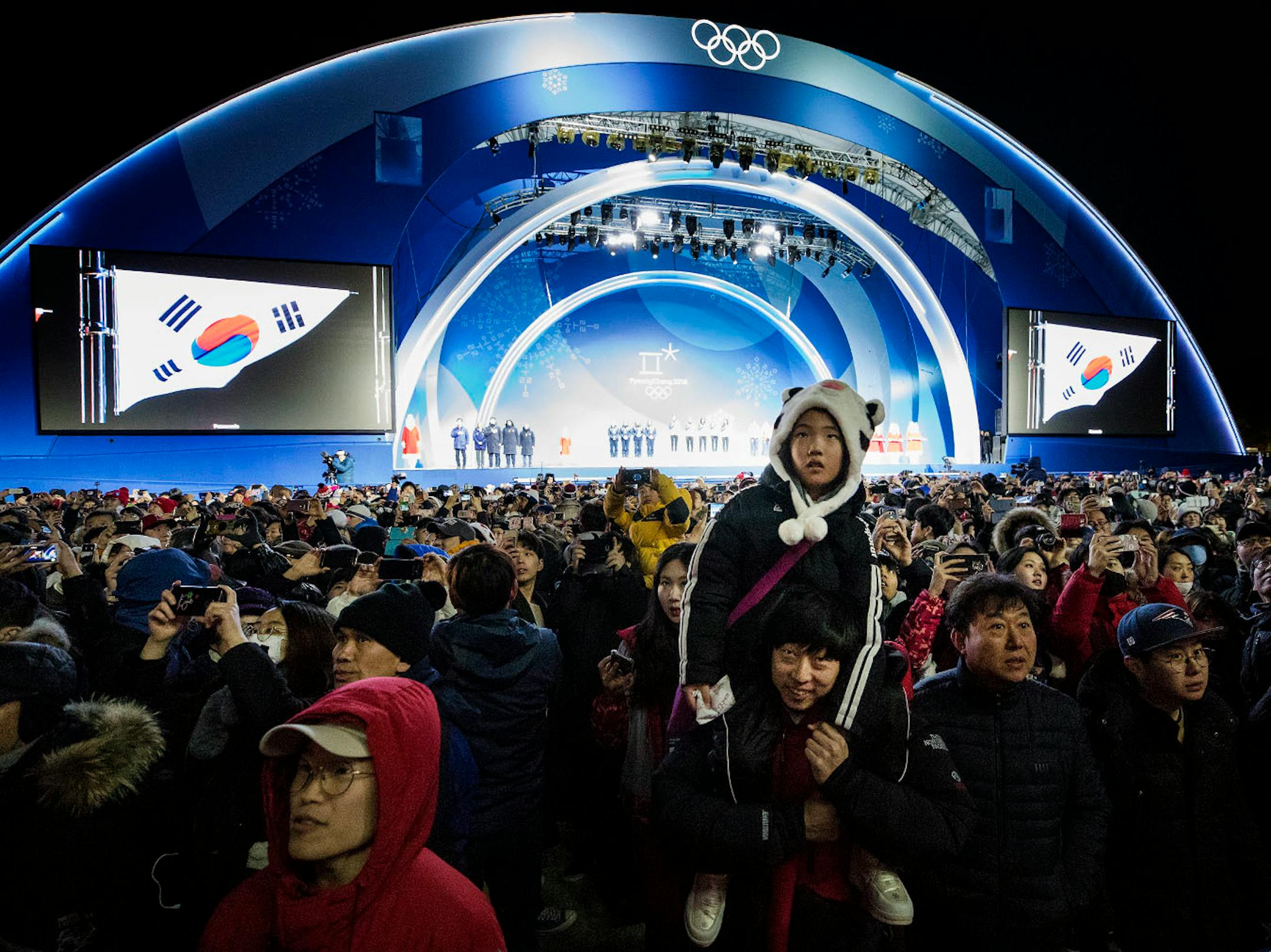 Spectators faced the flag as the South Korean National Anthem played after the team was presented with the Gold Medal for the Women's Short Track Speed Skating 3000m Relay at Pyeongchang Olympic Plaza on Wednesday.
