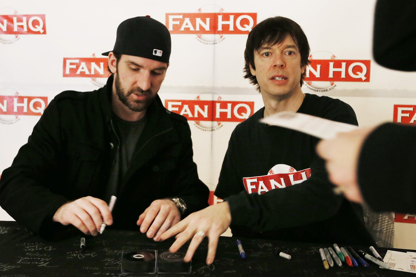 Minnesota Wild goal keeper Josh Harding left signed autographs as Shaun Hagglund owner of Fan HQ store in Ridgedale Mall looked on Sunday Feb 02, 2014 in Minnetonka ,MN. JERRY HOLT &#x201a;&#xc4;&#xa2; jerry.holt@startribune.com