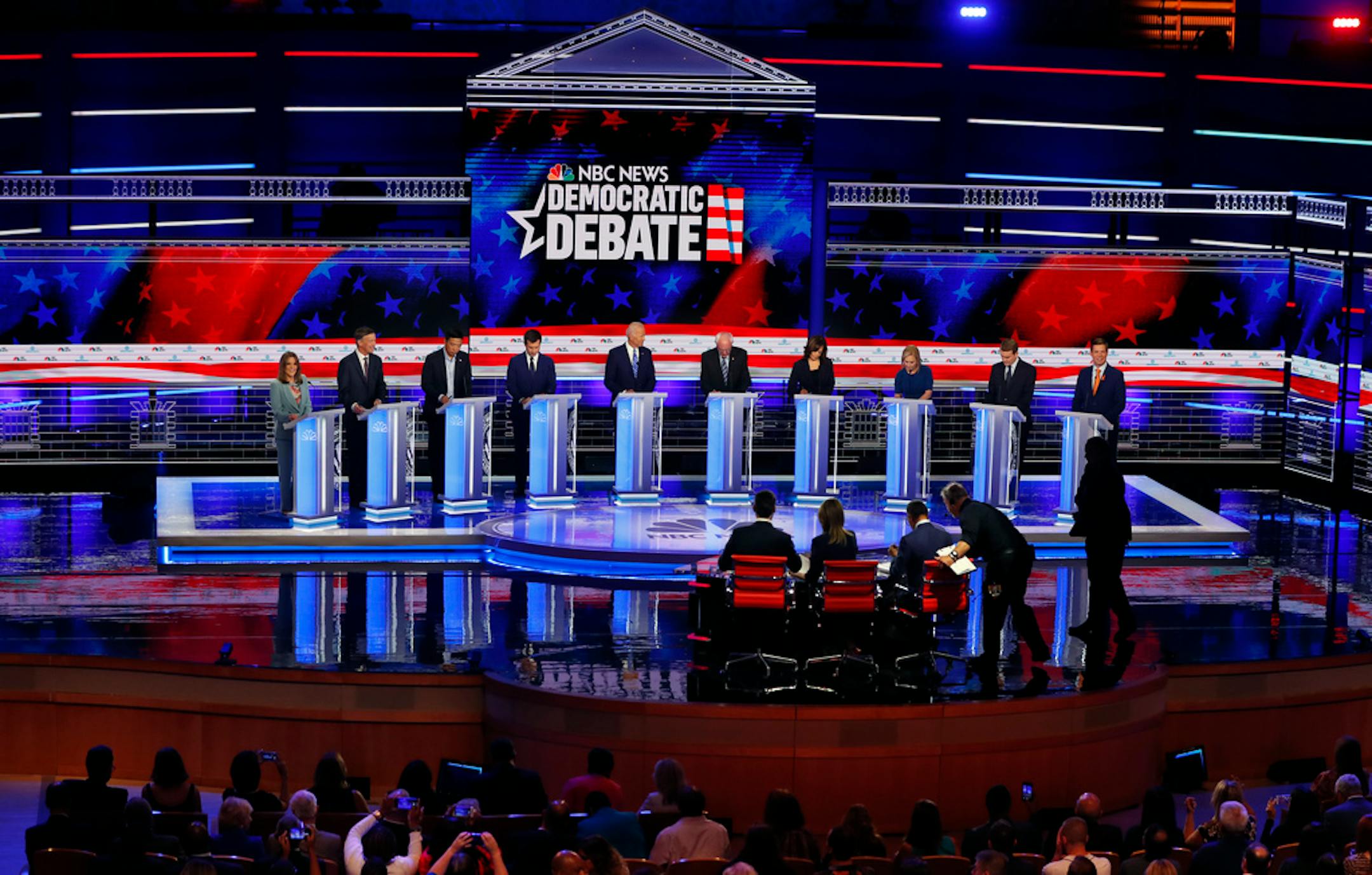 Democratic presidential candidates, author Marianne Williamson, former Colorado Gov. John Hickenlooper, entrepreneur Andrew Yang, South Bend Mayor Pete Buttigieg, former Vice President Joe Biden, Sen. Bernie Sanders, I-Vt., Sen. Kamala Harris, D-Calif., Sen. Kirsten Gillibrand, D-N.Y., Colorado Sen. Michael Bennet, and Rep. Eric Swalwell, D-Calif., listen to a question during a Democratic primary debate hosted by NBC News at the Adrienne Arsht Center for the Performing Arts, Thursday, June 27, 2