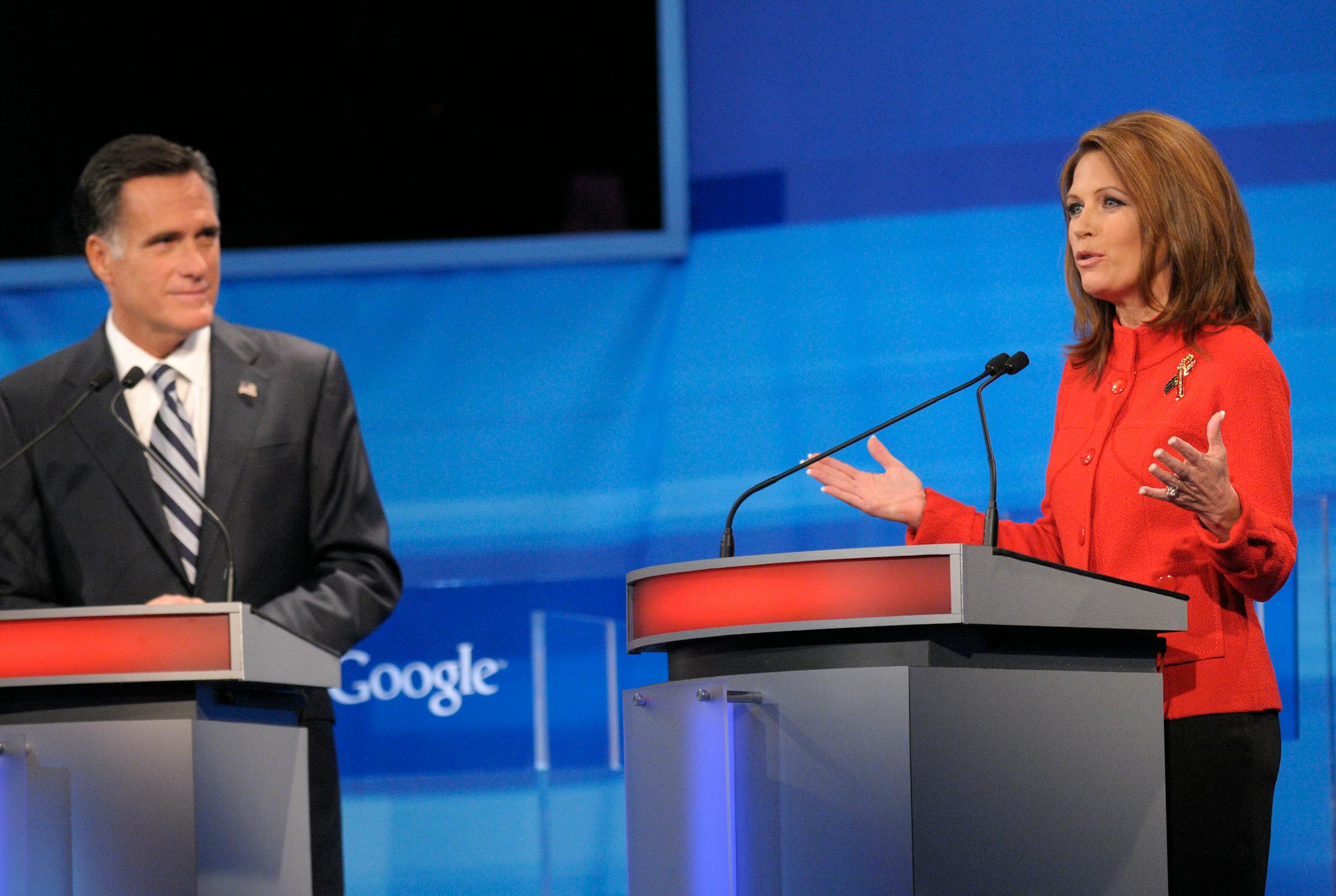 Republican presidential candidate Rep. Michele Bachmann, R-Minn., makes a comment as former Massachusetts Gov. Mitt Romney listens during a debate Thursday, Sept. 22, 2011, in Orlando, Fla. (AP Photo/Phelan M. Ebenhack, Pool)
