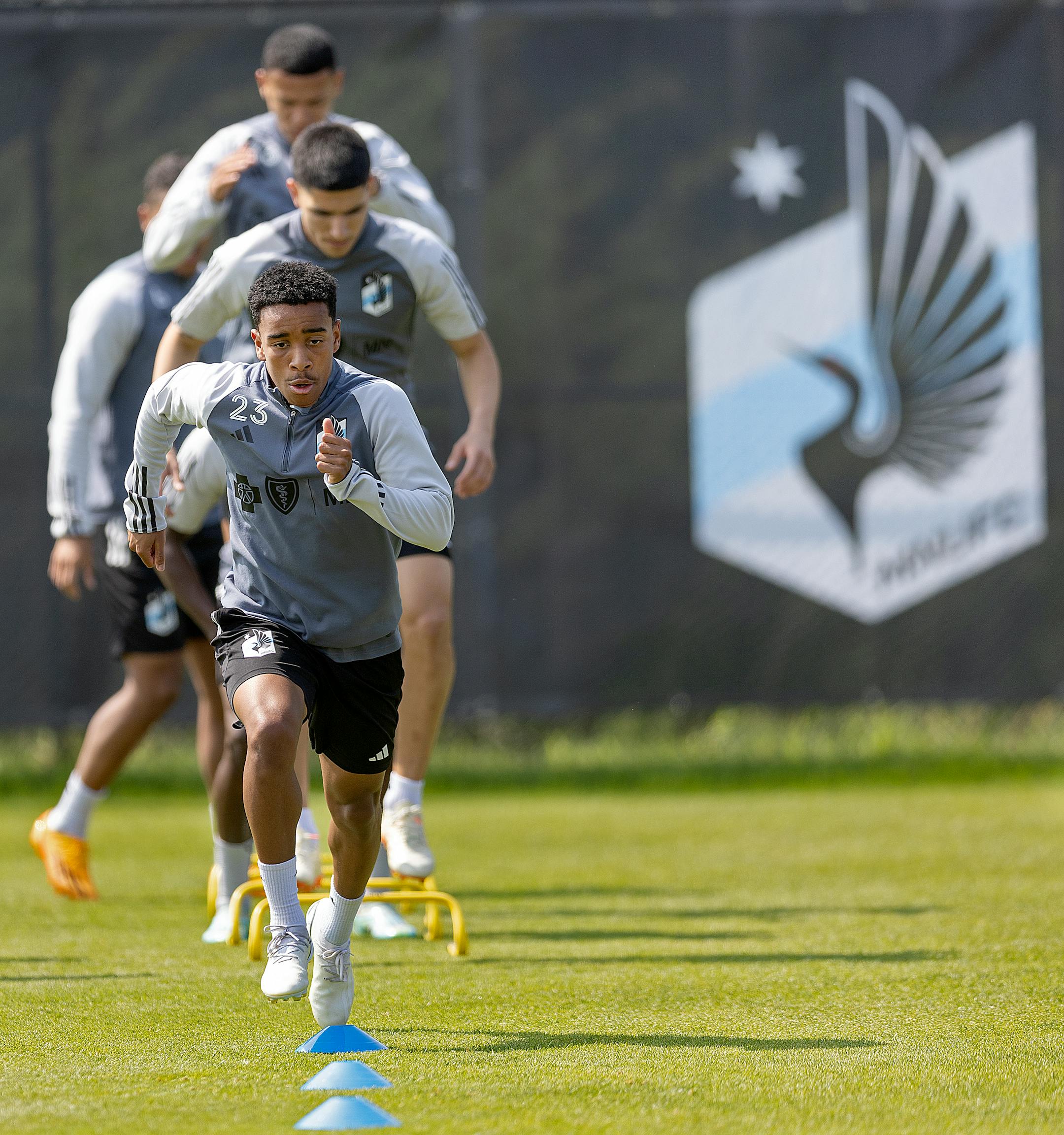 Minnesota United players including forward Cameron Dunbar warm up before a brief practice.