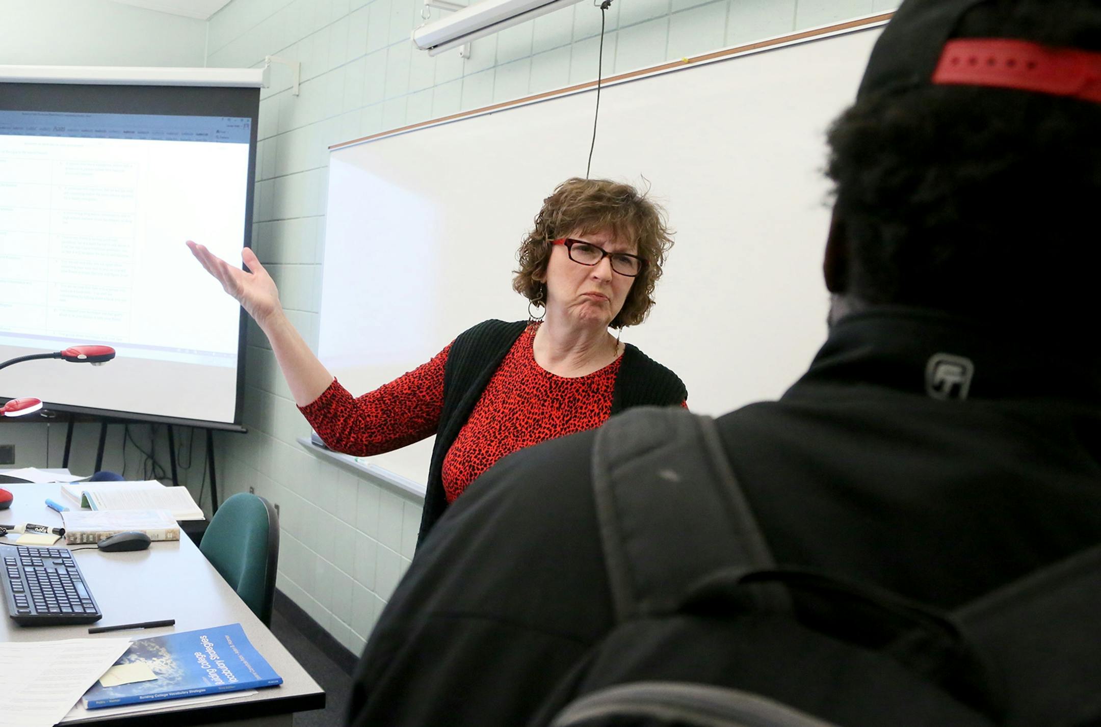 Laurel Watt is worried that proposed legislation would eliminate classes like her developmental reading class at Inver Hills Community College, that teach reading skills to struggling students -- half of the students in her class who are non-native English speakers. Here, at the end of class Watt tells a concerned student not to worry about a low quiz score because one will be thrown out Tuesday, March 17, at Inver Hills Community College in Inver Grove Heights, MN.