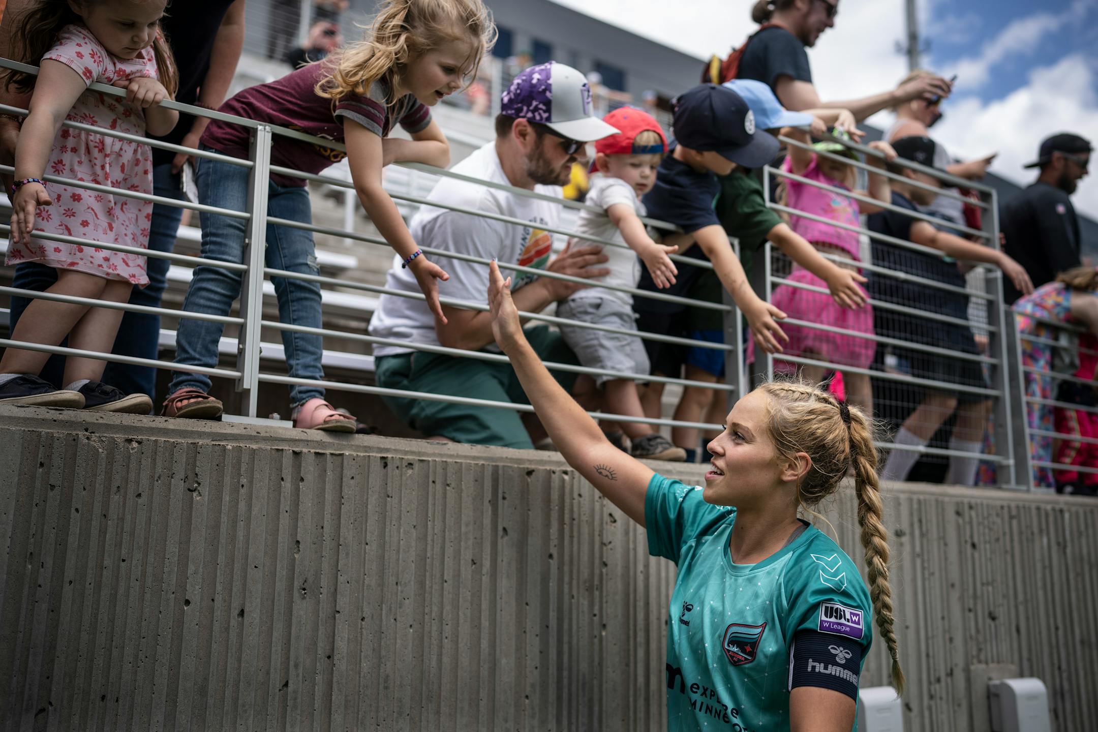 Minnesota Aurora's Morgan Stone celebrates with fans after the game.