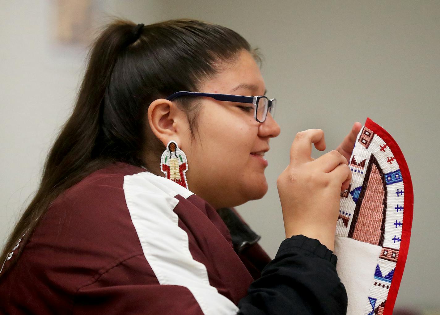 Native American Nina Berglund, 18, will travel to Rome to meet Pope Francis this spring, along with her mother Dianna Johnson and a group of other local Native Americans. Berglund was seen making making moccasins for her Pow Wow regalia Wednesday, March 14, 2018, at the St. Paul Public Schools Indian Education center in St. Paul, MN. Berglund is not Catholic but is an admirer of the Pope. "We just want a better future," she said about the trip to Rome.] DAVID JOLES &#xef; david.joles@startribune