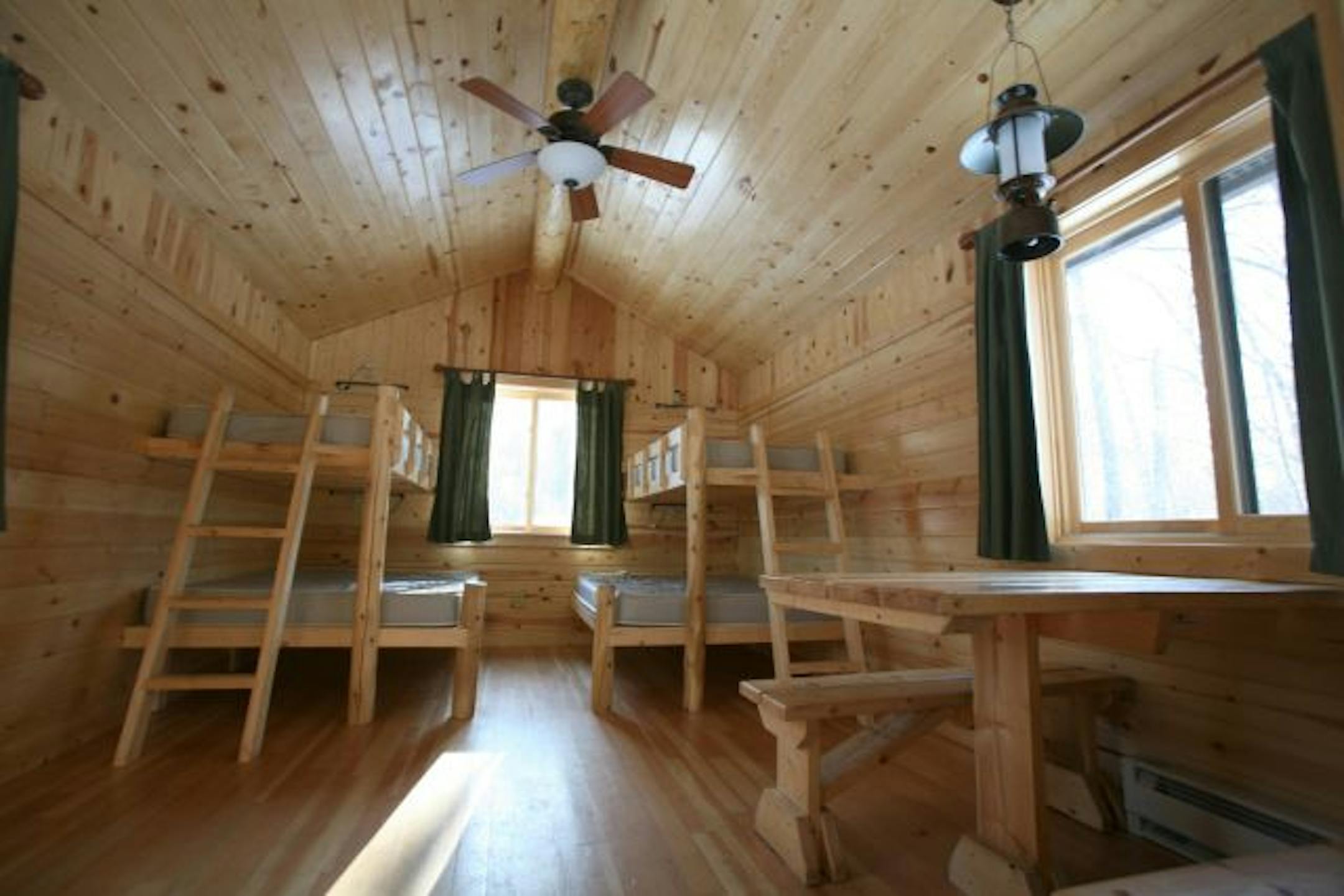 Camper cabins, like this one in Wild River State Park near Center City, Minn., offer travelers a comfortable alternative to tent camping. All have bunks with mattresses and a table, but no kitchen or bath (except for the shared facilities). Most also have heat and electricity.