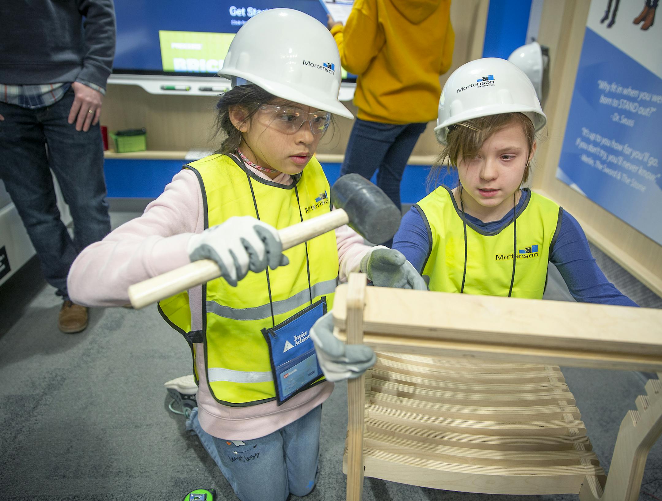 Rosemount Elementary fifth-graders Kathleen Tesoro, left, and Evie Bestick were mock project managers for Mortenson Copnstruction at Junior Achievement's "BizTown," Monday, February 4, 2019 in St. Paul, MN. The "BizTown" is a make-believe city with 18 storefronts. Before arriving, children apply and interview for jobs and then execute them. They take out loans from the bank, make purchases and tally sales at their shops. The center is part of Junior Achievement's new $20 million learning center.