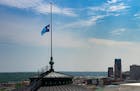 The new Minnesota state flag flies at half staff over the State Capitol in St. Paul on Wednesday in honor of officers killed or injured in the line of