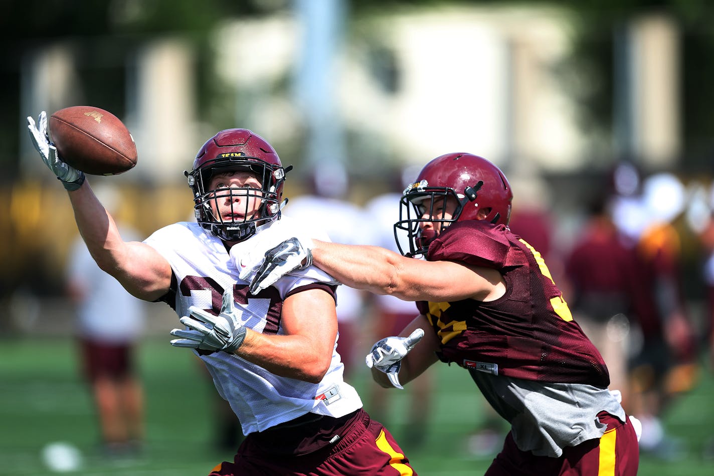 Linebacker Nick Rallis right tipped the ball from running back James Johannesson . The University of Minnesota football team had it's first full practice Monday August 10, 2015 in Minneapolis, MN. ] Jerry Holt/ Jerry.Holt@Startribune.com