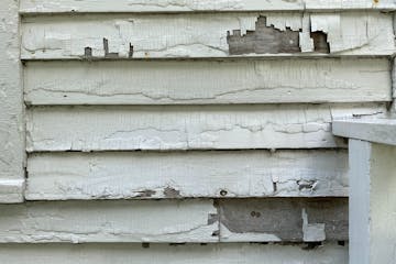 Peeling paint on the exterior of the John H. Stevens House in Minnehaha Park.