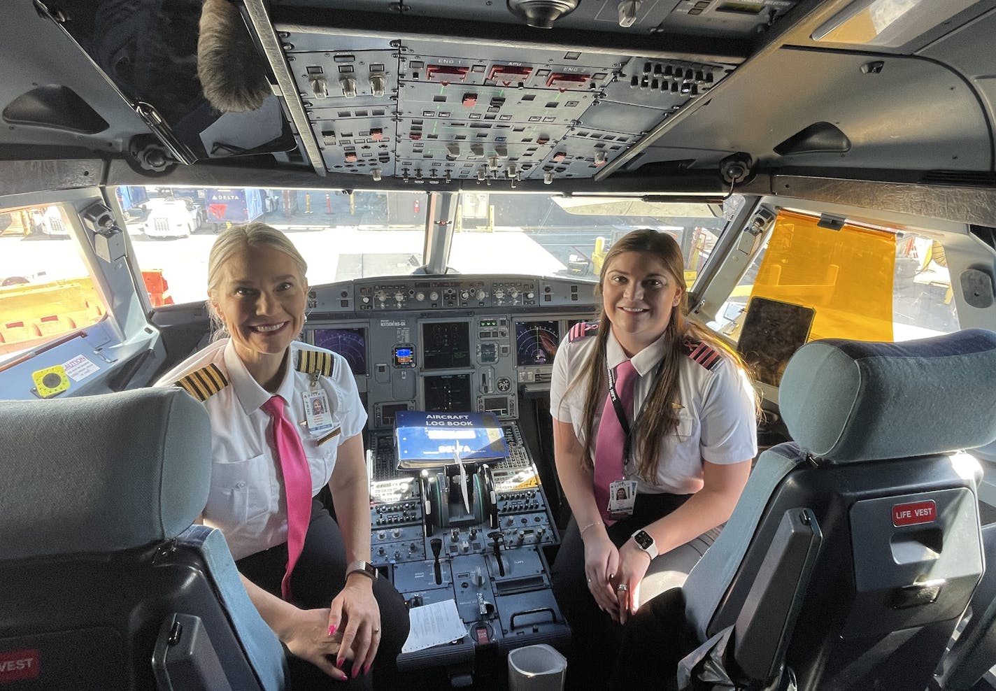 The two pilots in the cockpit of a Delta Air Lines plane.