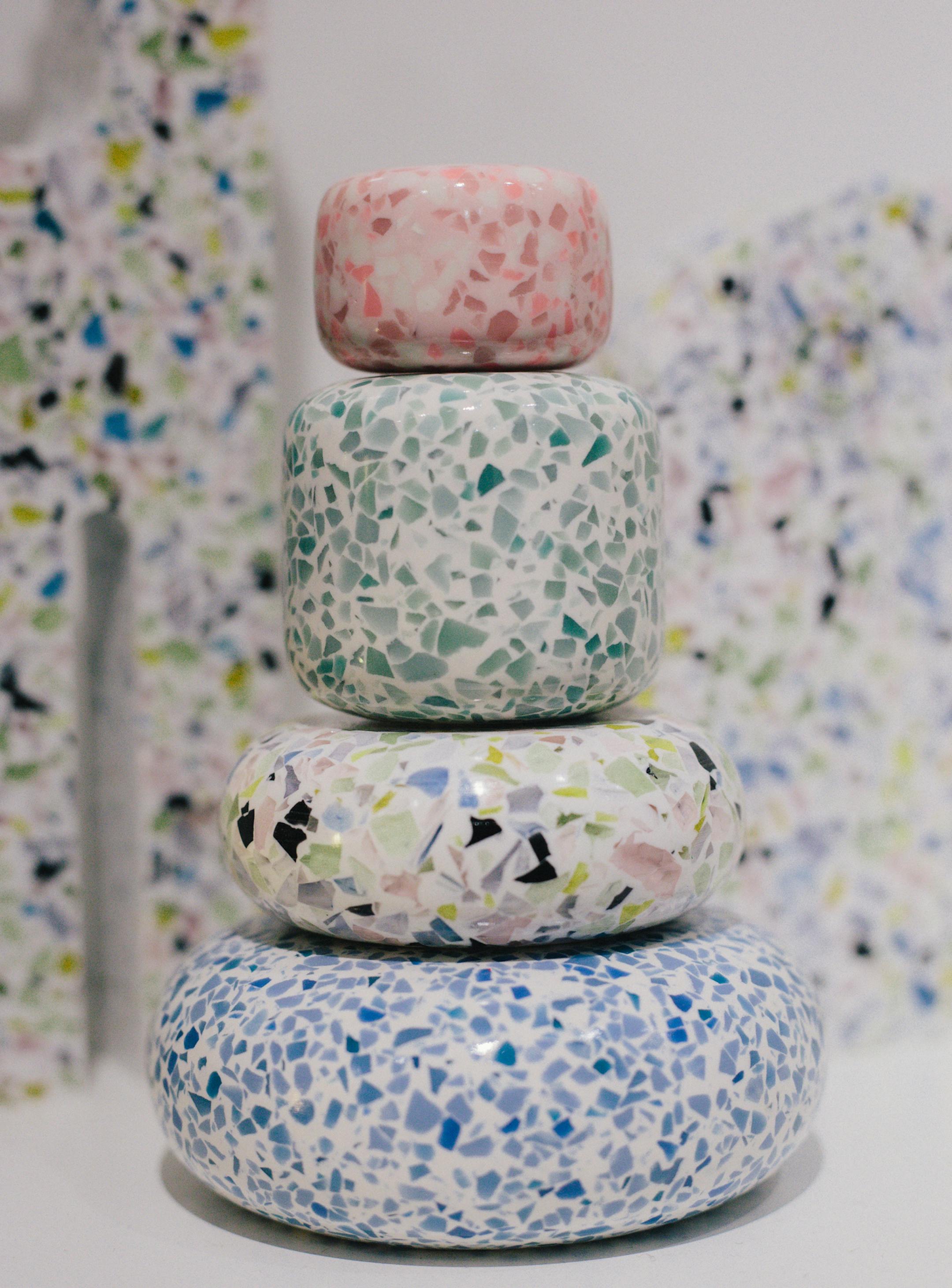 The collection features whimsical objects and furniture in mod black and white and postmodern pastels.