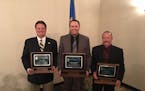 Minneapolis police officer Brent Rasmussen, center, was named Police Officer of the Year by the Minnesota Police and Peace Officers Association. He is