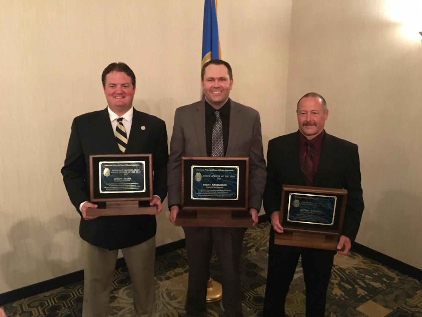 Minneapolis police officer Brent Rasmussen, center, was named Police Officer of the Year by the Minnesota Police and Peace Officers Association. He is flanked by runners up Officer Joseph Sauer of the St. Paul Police Department and Deputy Jeff Marshall of the Hennepin County Sheriff's Office.