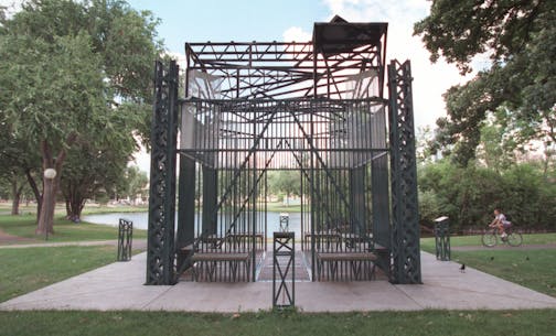 Loring Park Gazebo, overlooking Loring Lake near the Irene Hixon Whitney Bridge, 15th St. and Hennepin Av. S., Minneapolis. Dedicated in 1993, the blue-green gazebo is a latticework cube of painted steel fitted with wooden benches. A gift of the Wheelock Whitney family to the city of Minneapolis, the sculpturelike gazebo is a further link between the park and the nearby sculpture garden. Like much of Armajani's work, the gazebo incorporates poetry, in this case three reading stands bearing quota