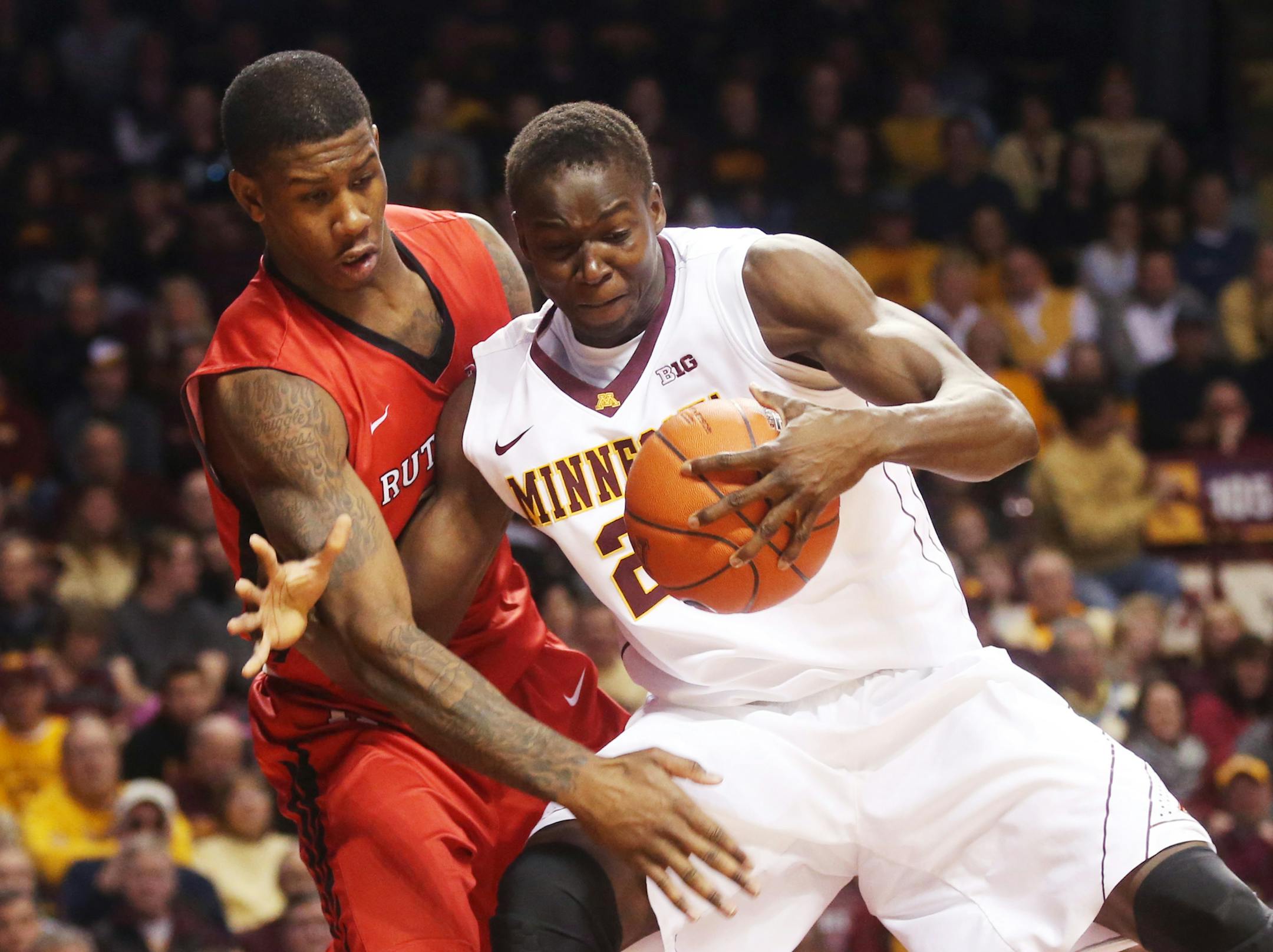 Minnesota&#x2019;s Bakary Konate, right, of Mali, gets tangled up by Rutgers&#x2019;s Greg Lewis in the second half of an NCAA college basketball game, Saturday, Jan. 17, 2015, in Minneapolis. Lewis was called for a foul on the play. Minnesota won 89-80. (AP Photo/Jim Mone)