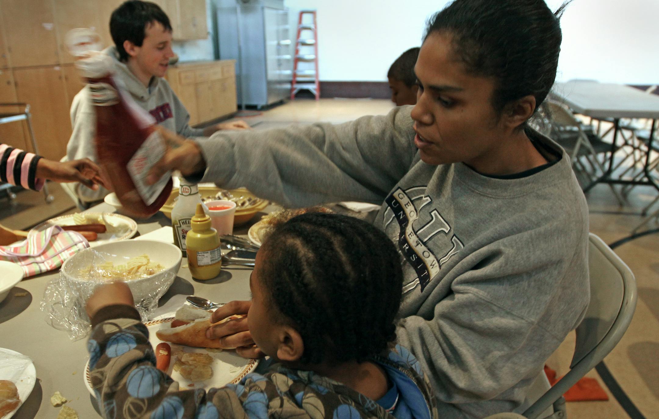 Turena Vitela ate lunch with her son Jevon at The Family Place on Thursday. Staff would like to hire housing specialists to help families find permanent housing, but don't have the money for it.