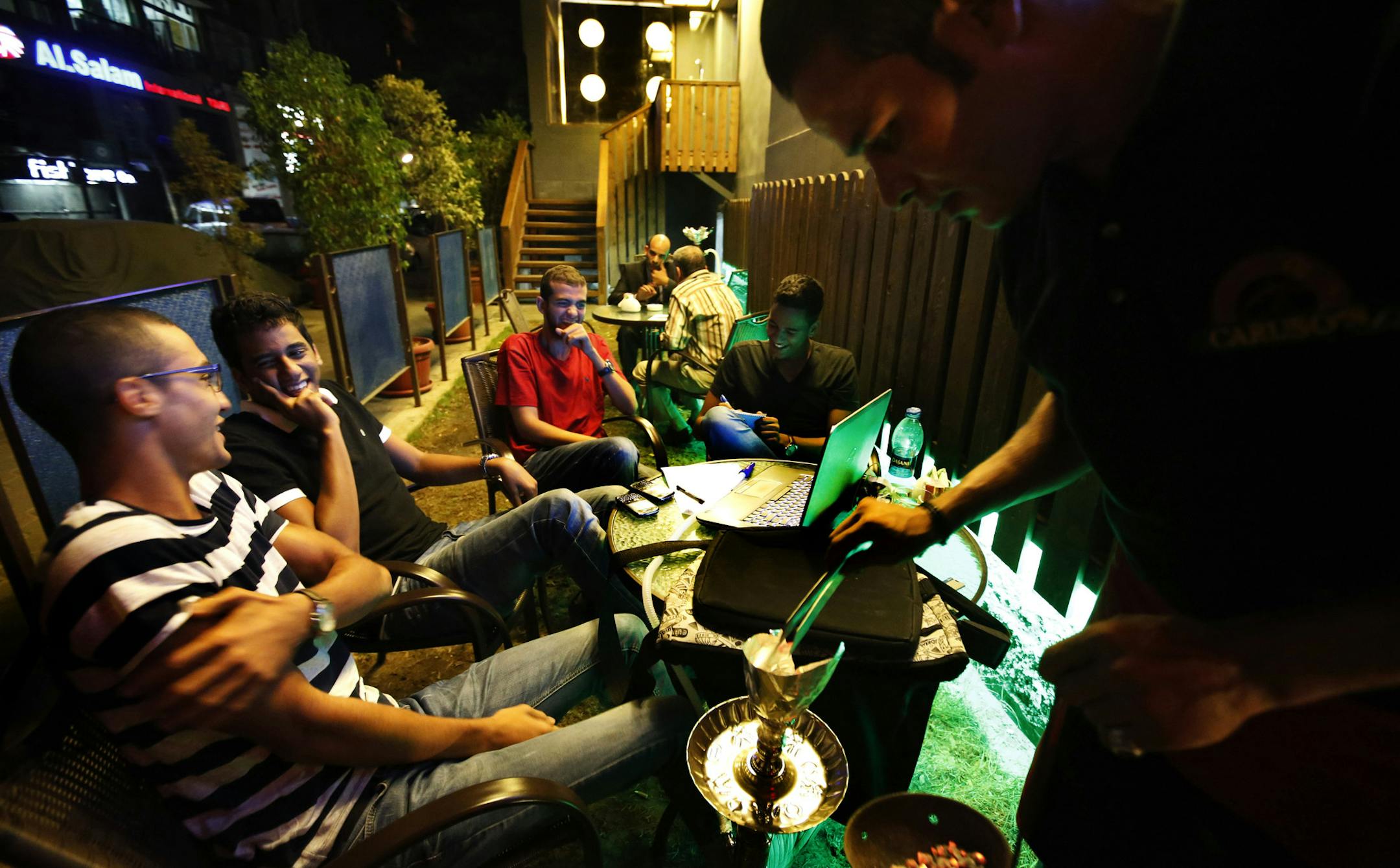 In this Sunday, Aug. 25, 2013 photo, students study at a coffee shop in Cairo, Egypt, during curfew. The curfew has been a shock to Cairo, a city where cafes stay packed into the night and parents routinely take their children out for dinners nearing midnight. The military-backed governmentís curfew, after violent unrest following the July 3 coup that ousted President Mohammed Morsi, slashed the typical Cairo 24-hour life to just 11 hours. (AP Photo/Lefteris Pitarakis)