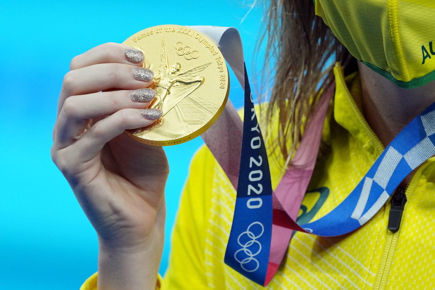 Australia's Ariarne Titmus displays her gold medal after winning the women's 200 meter freestyle finals