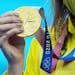 Australia's Ariarne Titmus displays her gold medal after winning the women's 200 meter freestyle finals