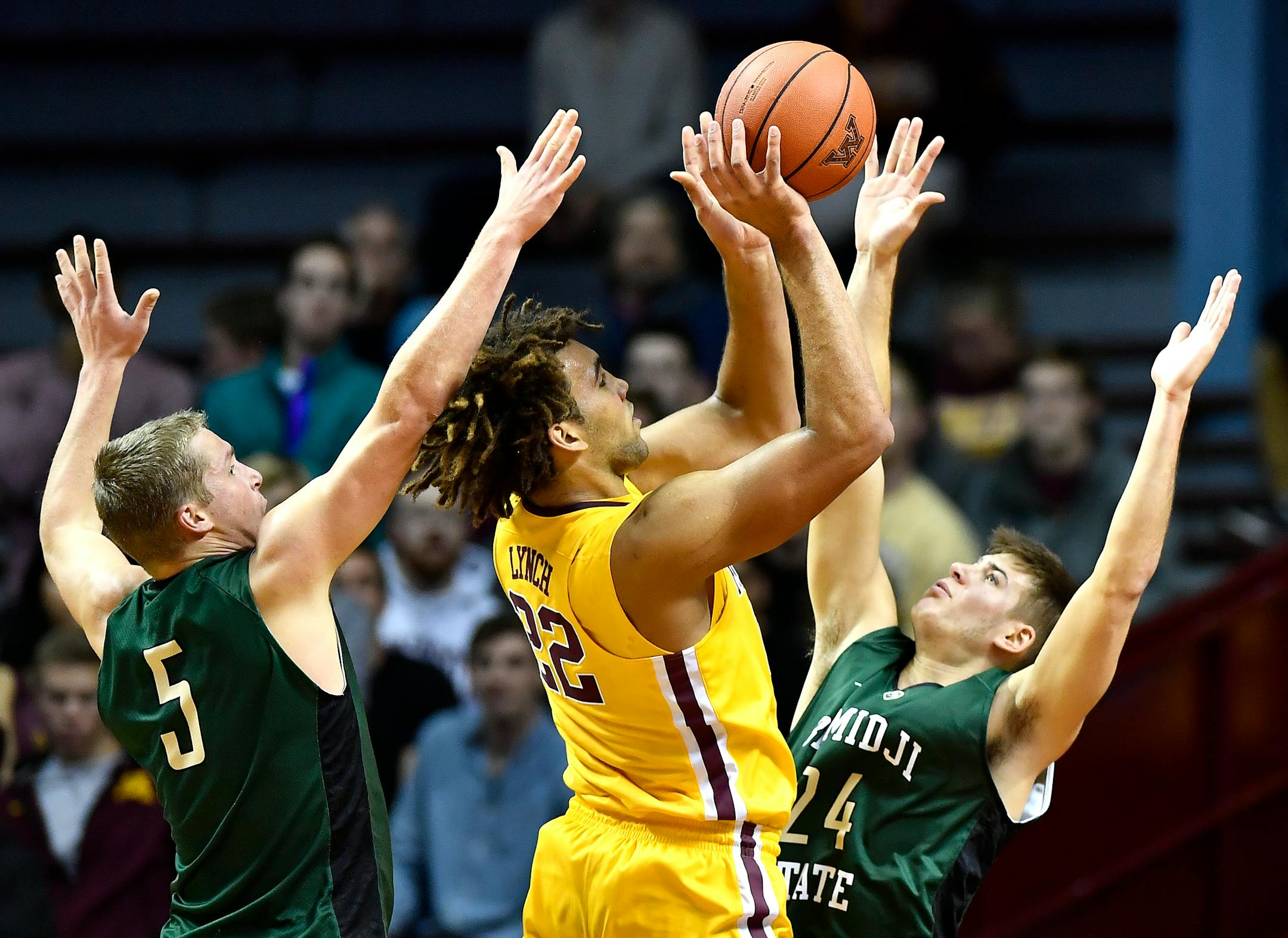 Minnesota Gophers center Reggie Lynch (22) attempted a shot in the paint while being defended by Bemidji State forward Ben Best (5) and forward Logan Bader (24) in the first half Thursday.
