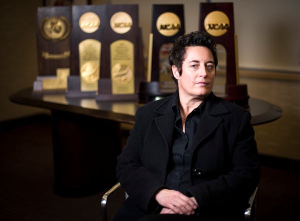 University of Minnesota Duluth womens' hockey head coach Shannon Miller is pictured in front of her five NCAA National Championship trophies in her of