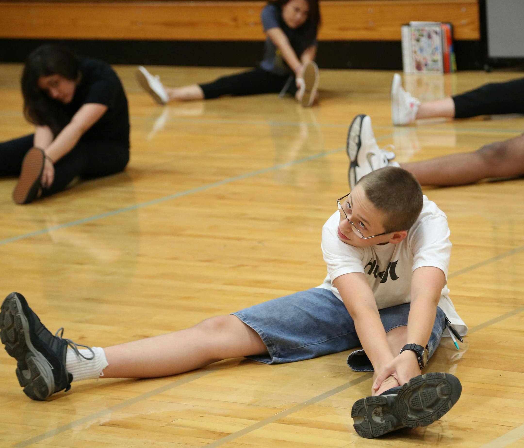 Jerell Smith, 14, reached to touch his toes during class warmups. The Minneapolis public school district has a new program that allows qualified students to be waived from taking physical education.