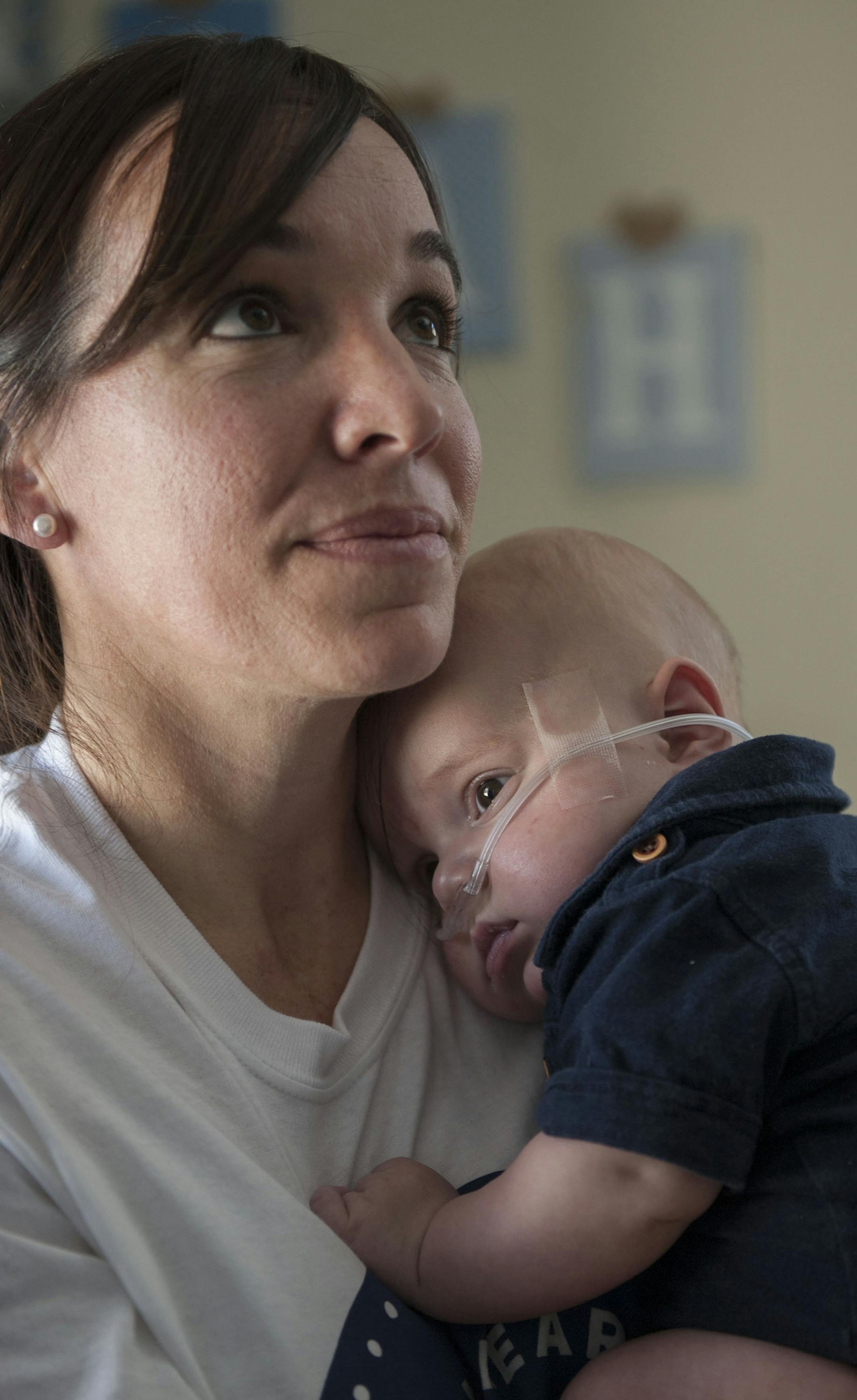 Niccole Connally has spent most hours of the day holding her son, Noah Connally, 5 months, in order to make him comfortable and monitor his vitals. Noah Connally was born with hypoplastic left heart syndrome which left him with half a heart. His parents are trying to raise funds for the last two of three surgeries that will increase his chances for survival. (Ana Venegas/Orange County Register/TNS)