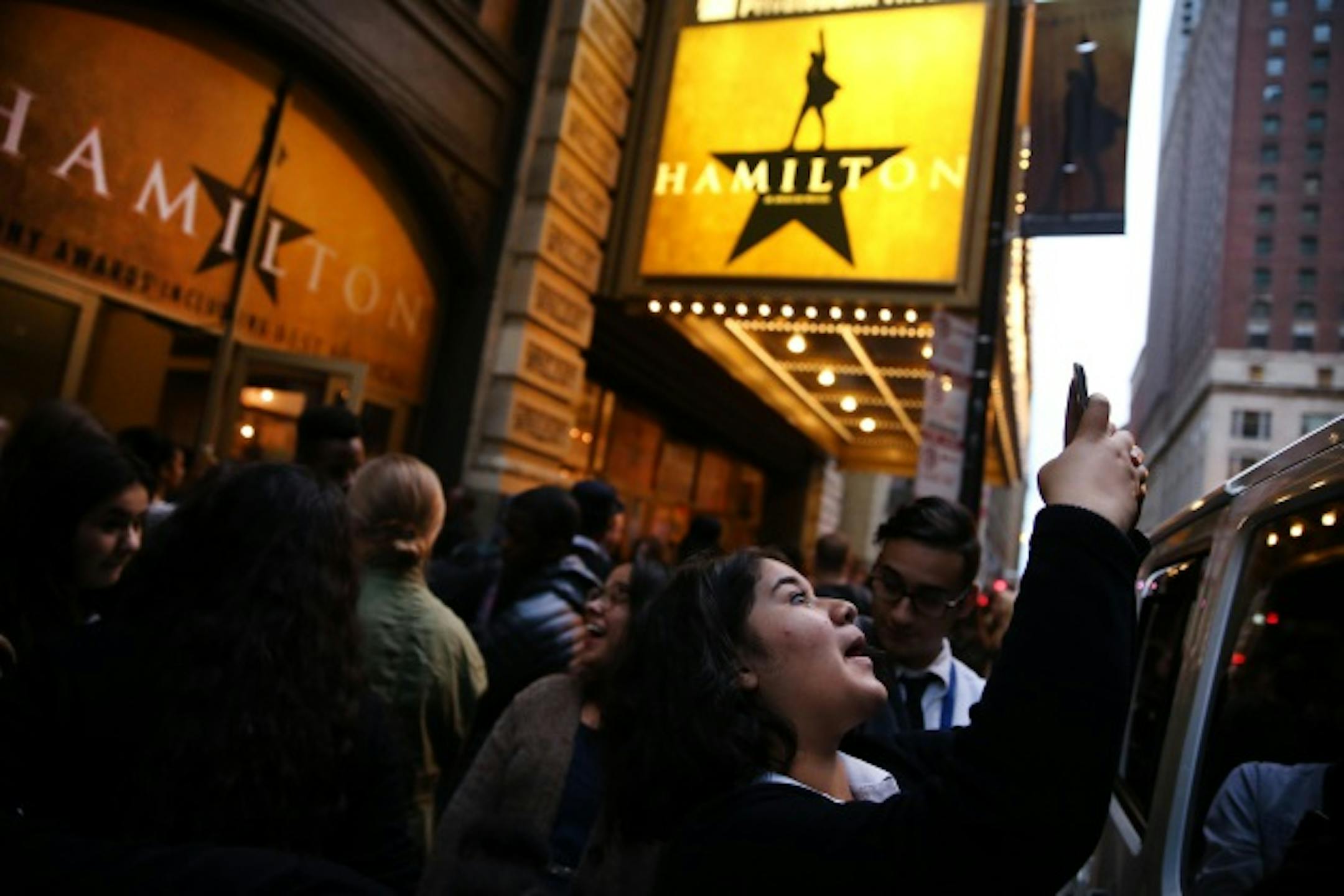 Diana Andrade, 17, takes a photograph outside the PrivateBank Theatre where Hamilton is making it's Chicago premiere on Wednesday, Oct. 19, 2016 in Chicago. Andrade was among a group of students from Chicago Hope Academy who were attending the premiere.  (Chris Sweda/Chicago Tribune/TNS) ORG XMIT: 1191947