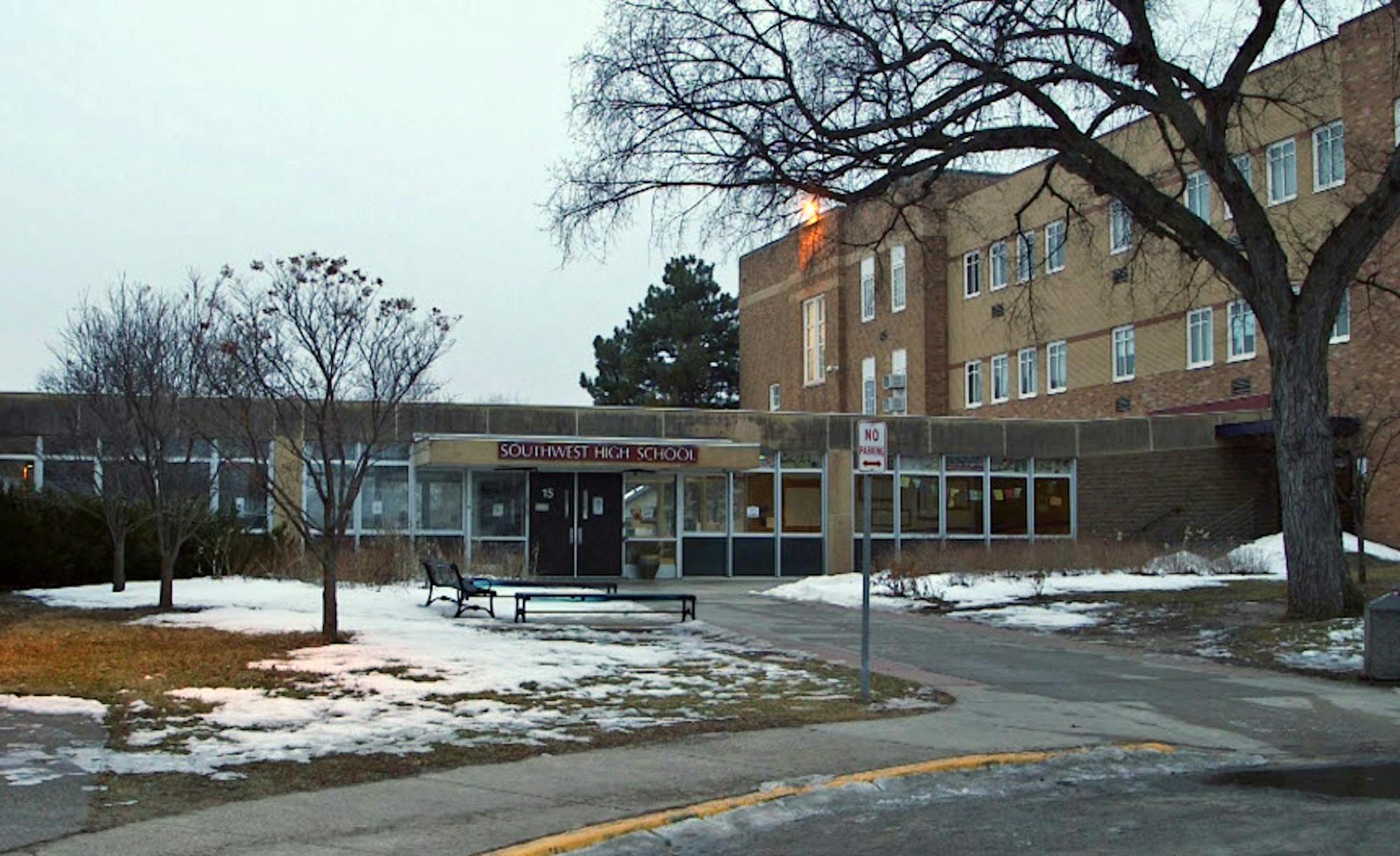 The four people charged were allowed into Southwest High School through an entrance that was locked from the outside.