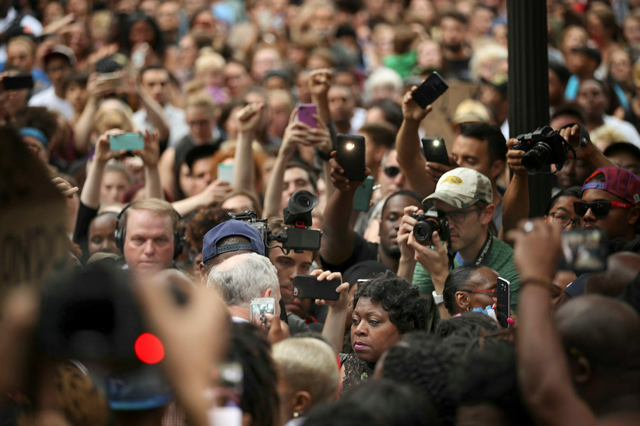 Governor Mark Dayton spoke briefly with Valerie Castile, the mother of Philando Castile, in a thick crowd in front of the governor's residence on Summit Ave.