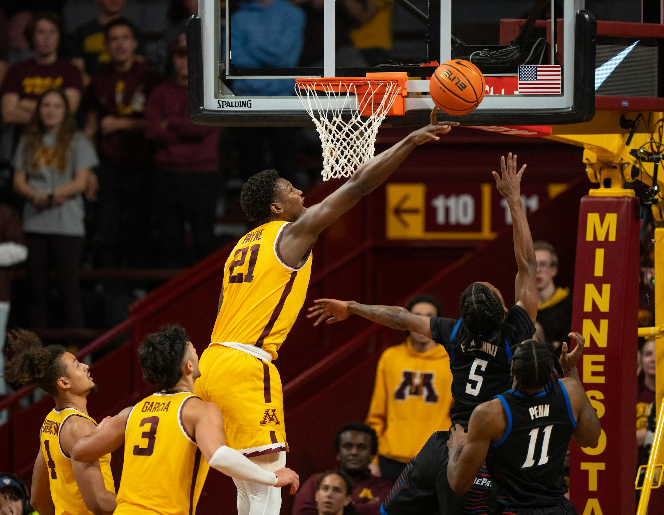 Minnesota Gophers forward Pharrel Payne (21) got a finger on a ball shot by DePaul Blue Demons guard Philmon Gebrewhit (5), enough to block the shot in the second half.