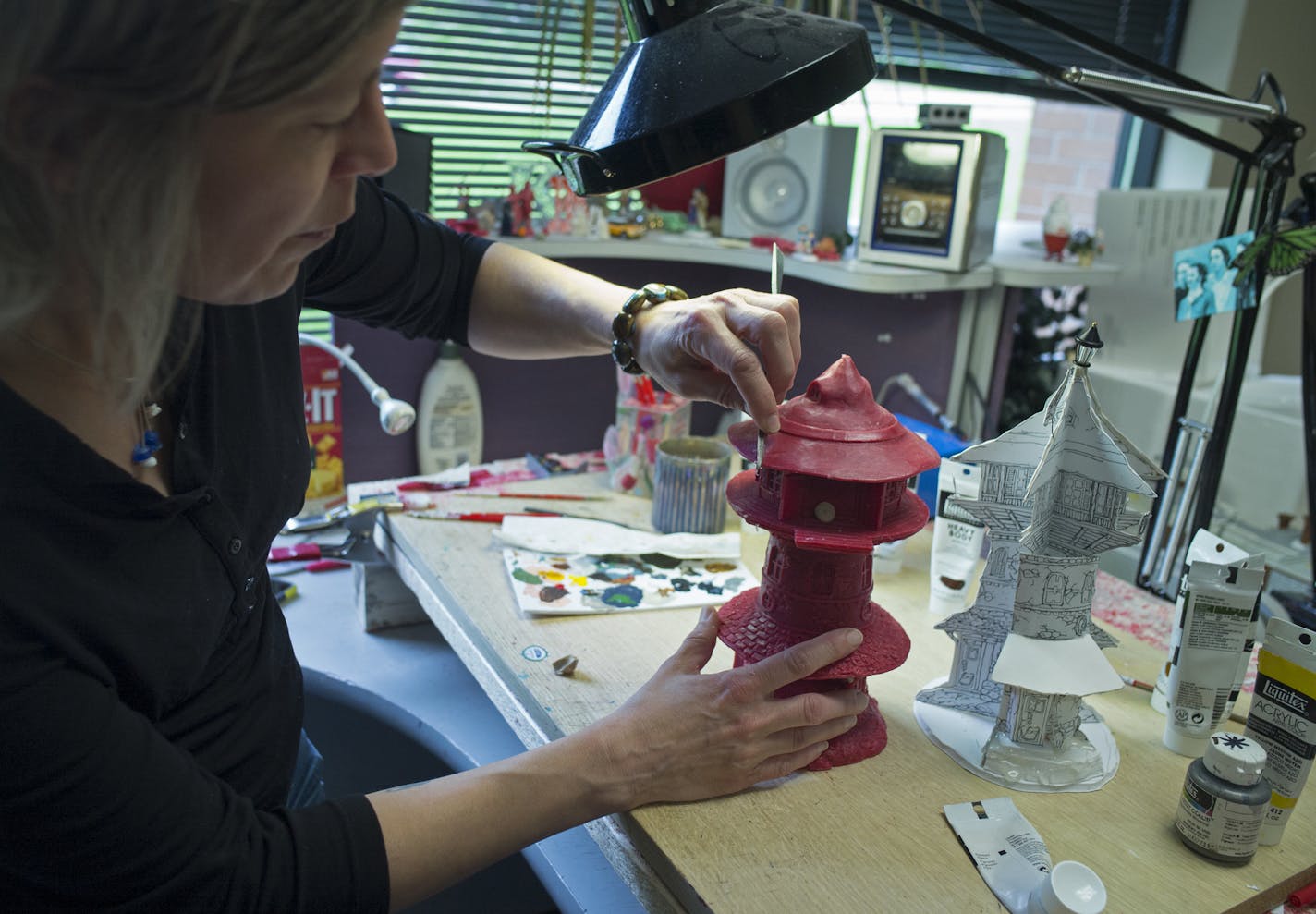 At Department 56 offices in Eden Prairie, sculptor Lori Namtvedt, who has been there 16 years molds a wax witch tower for pre-production .] Richard Tsong-Taatarii/rtsong-taatarii@startribune.com