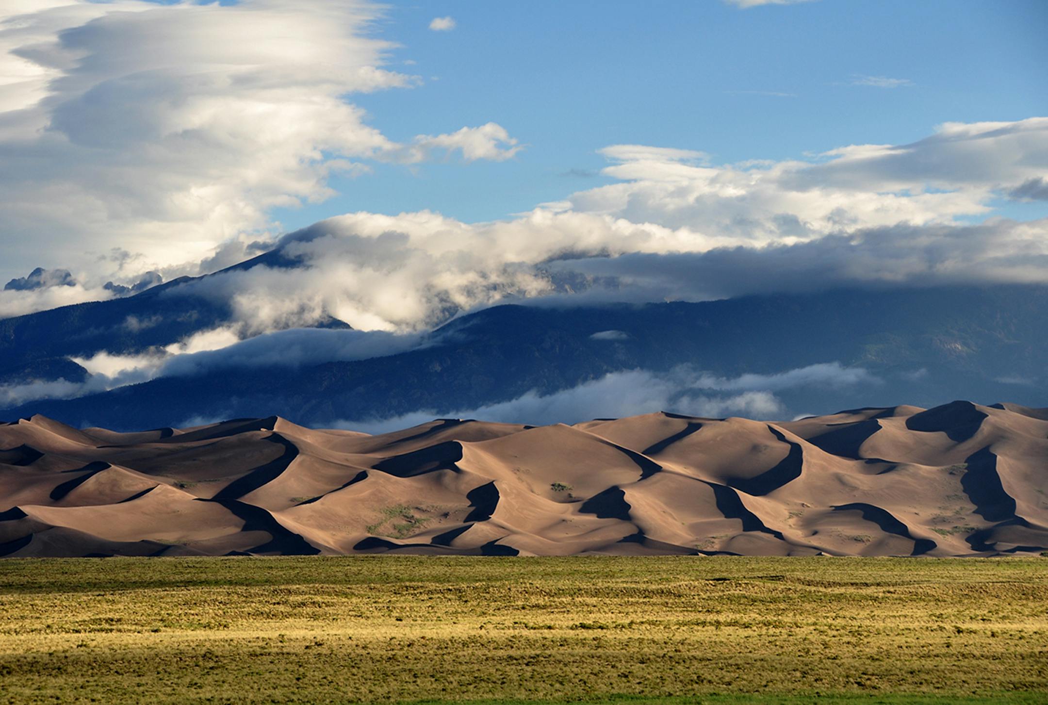 The drive into Great Sand Dunes National Park and Preserve shows a dramatic landscape.