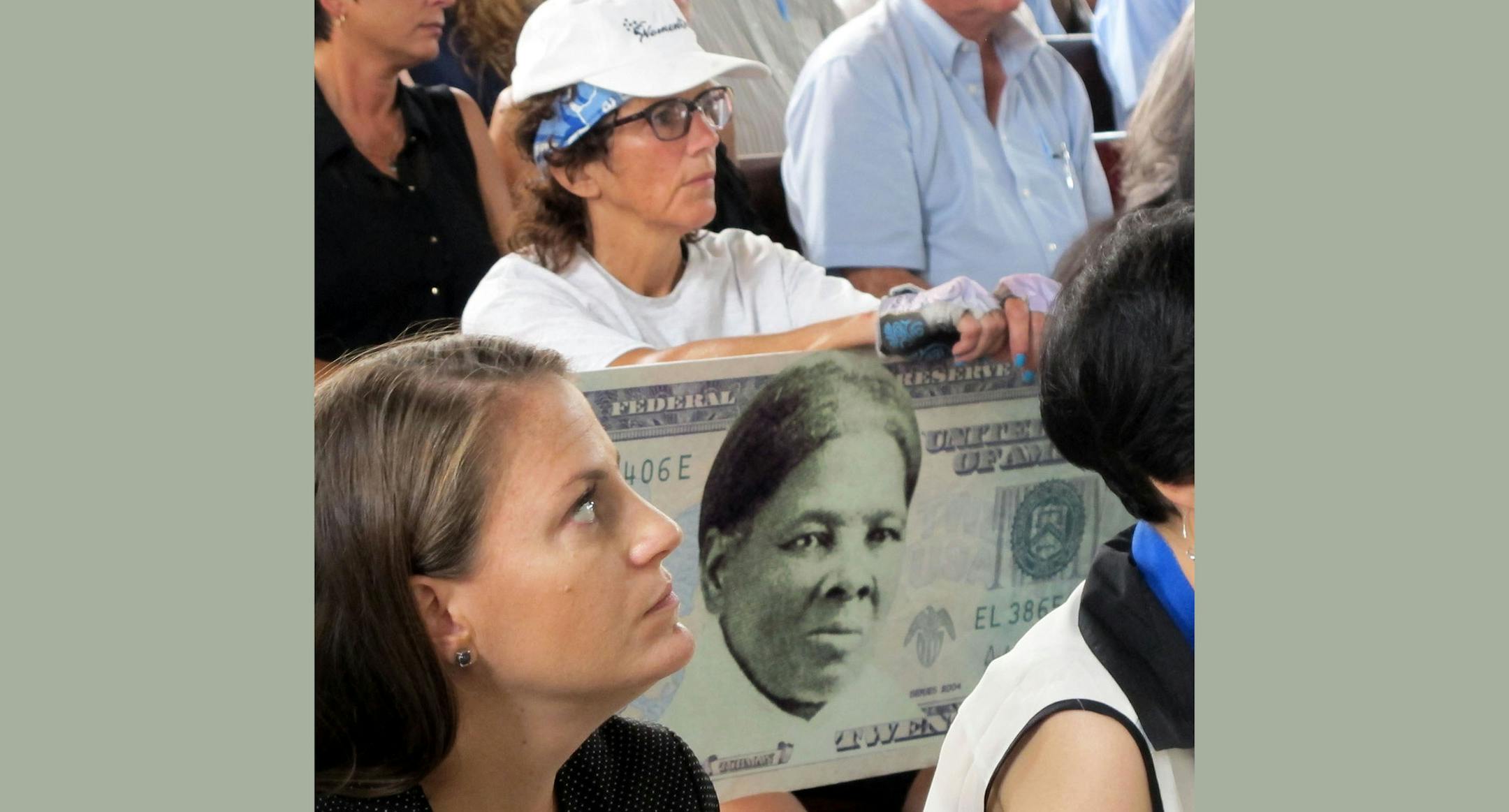 A woman holds a sign supporting Harriet Tubman for the $20 bill Monday, Aug. 31, 2015, during a town hall meeting at the Women's Rights National Historical Park in Seneca Falls, N.Y. Although the meeting with U.S. Treasurer Rosie Rios was part of plans to redesign the $10 bill, several in attendance said they wanted to see a woman on the $20 bill, too. (AP Photo/Carolyn Thompson) ORG XMIT: NYR105