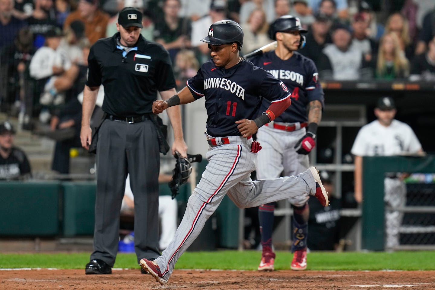 Minnesota Twins' Jorge Polanco scores on a wild pitch from Chicago White Sox relief pitcher Gregory Santos during the eighth inning of a baseball game, Saturday, Sept. 16, 2023, in Chicago. (AP Photo/Erin Hooley)