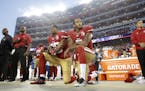 FILE - In this Sept. 12, 2016, file photo, San Francisco 49ers safety Eric Reid (35) and quarterback Colin Kaepernick (7) kneel during the national an
