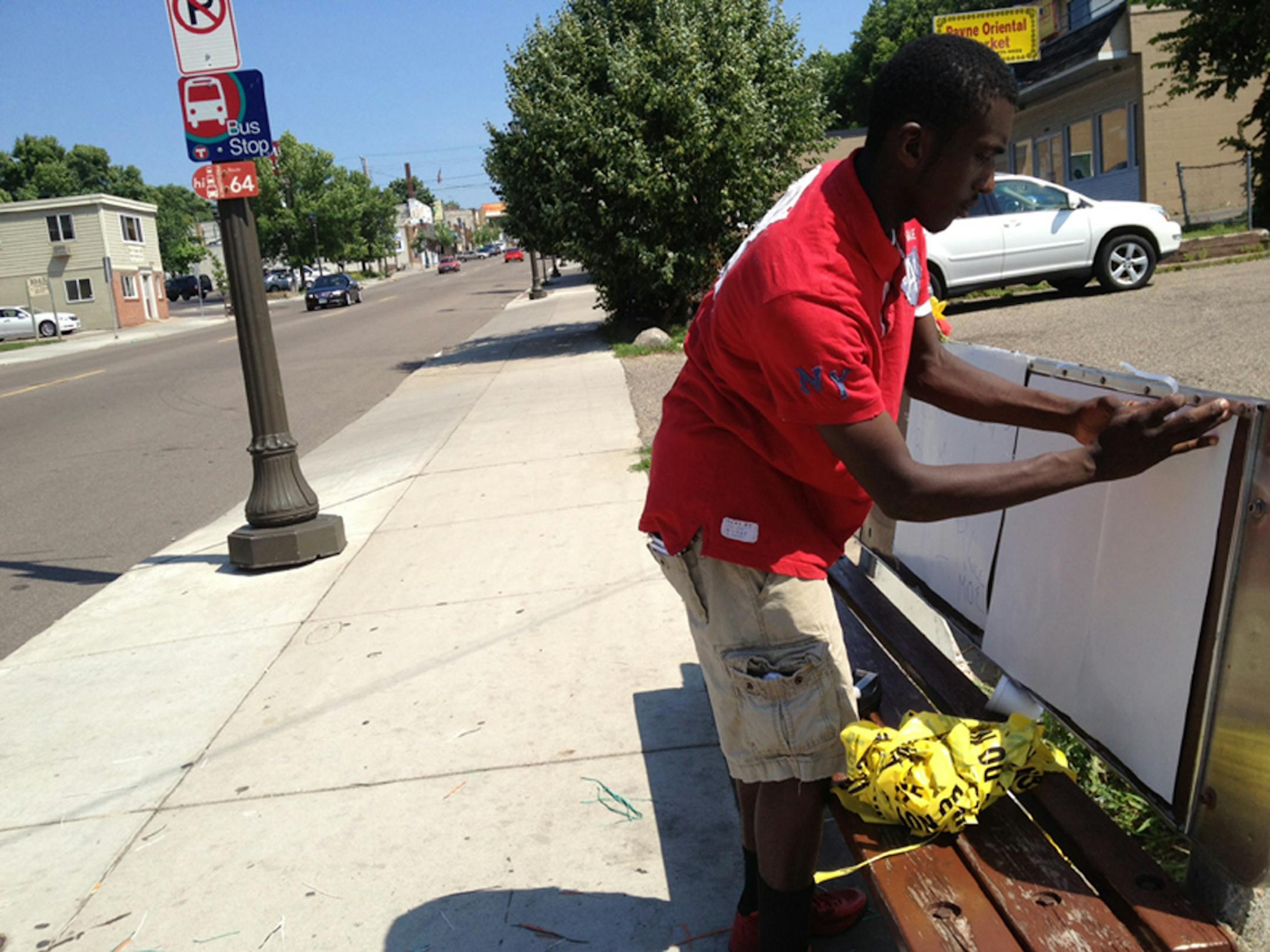 Jkuan Epps, 17, put up memorial signs near the corner of Payne and Lawson avenues in St. Paul, where his friend was shot and killed Thursday night.