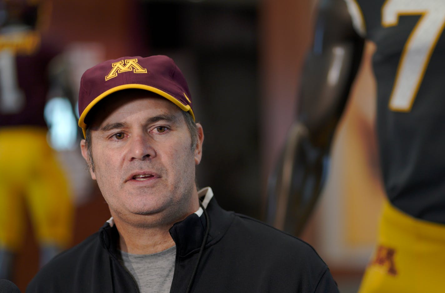 Kirk Ciarrocca, U of M Offensive coordinator, talking with reporters after practice Thursday morning at the Larson Performance Center at the U's Athletes Village. ]