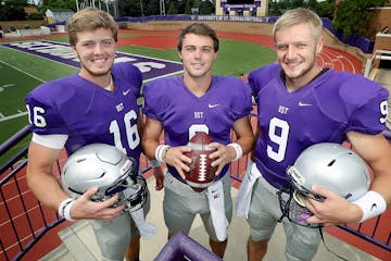 St. Thomas quarterbacks Jacques Perra, left, Gabe Green, center, and Alex Fenske, at the St. Thomas University Football Field, Thursday, August 25, 20