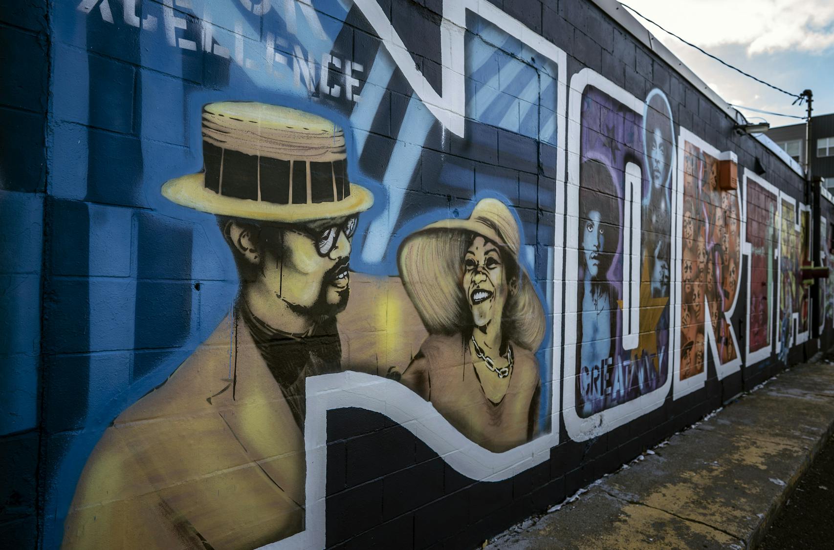 His newest and most personal mural features faces familiar to North Side residents, including Houston White and his late wife, Donise (pictured inside the 