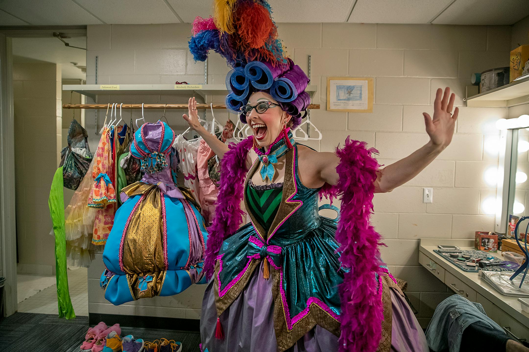 Autumn Ness reacts in her fastened corset in the dressing room for a dress rehearsal for the Theatre's production of "Cinderella."