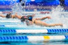 Gretchen Walsh swims during the women's 100-meter butterfly finals Sunday at the U.S. swimming Olympic trials in Indianapolis.